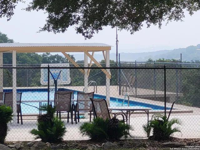 a view of a balcony with chairs and table
