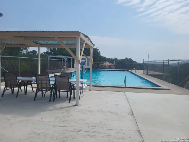 a view of a patio with a table and chairs