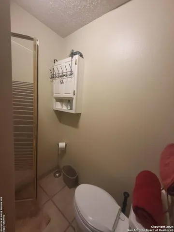 a white toilet sitting next to a bathroom sink and vanity