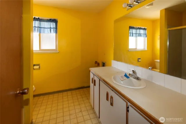 a bathroom with a sink and a mirror