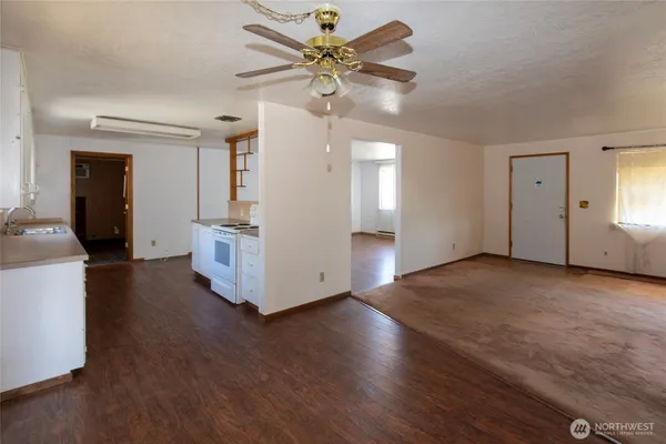 a view of a livingroom with a hardwood floor and a ceiling fan
