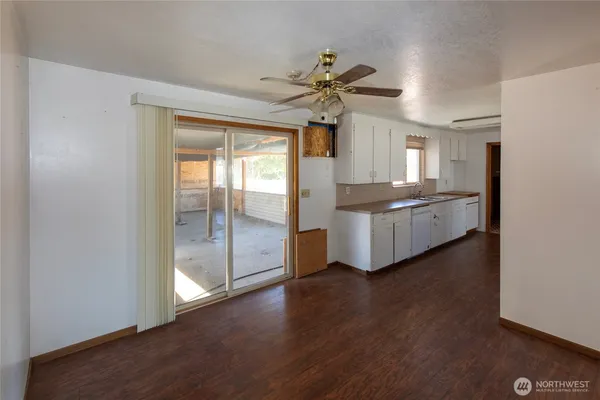 a kitchen with granite countertop stainless steel appliances a counter top space and a window