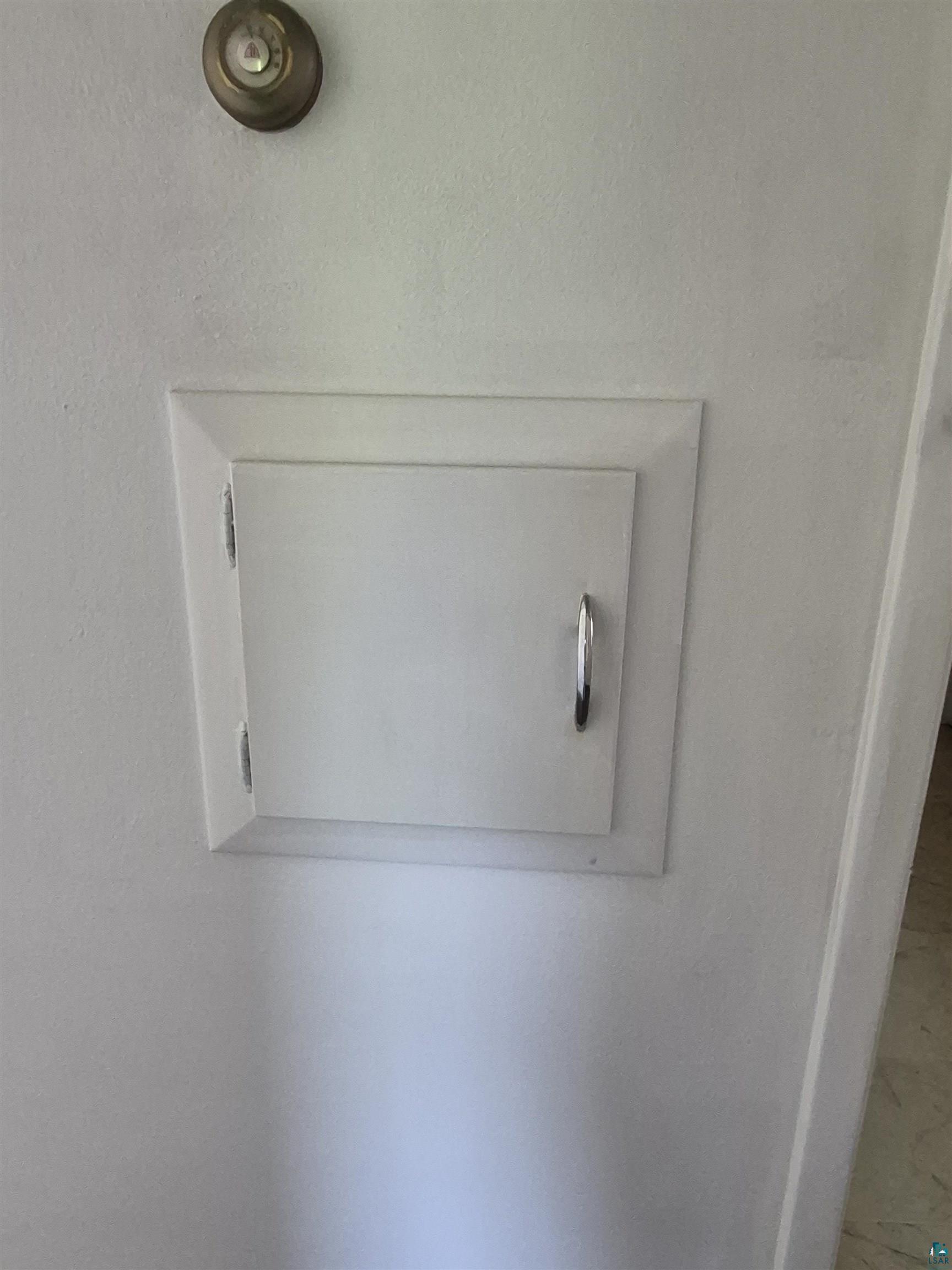 2109 West 22nd Street Duluth, MN 55811 - Photo 11 of 29 Recessed wall panel with a white finish, featuring a silver-tone pull handle and visible hinges