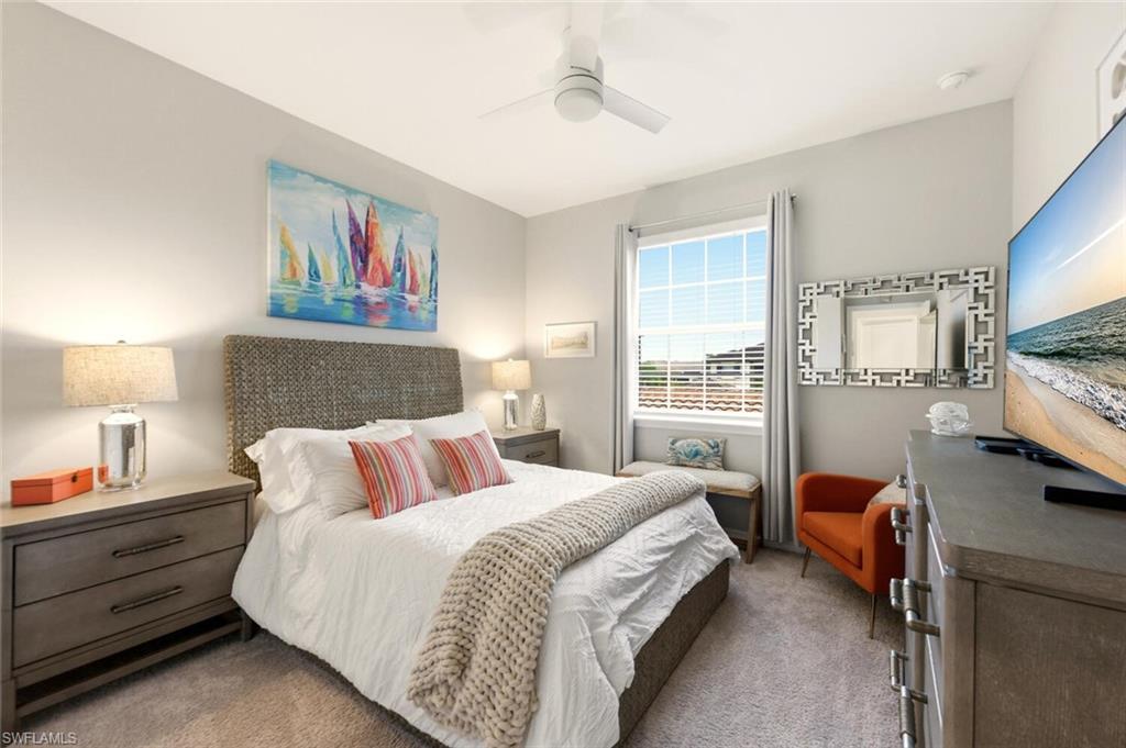 9365 Pocida Court, Unit 202 Naples, FL 34119 - Photo 22 of 40 a bedroom with a bed and wooden floor