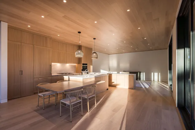 a large kitchen with a table and chairs