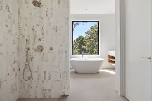 a white tub sitting next to a window