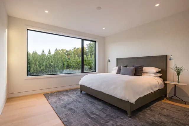 a bedroom with a large bed and a large window