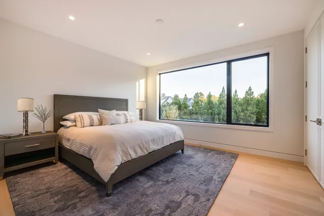 a bedroom with a large bed and a large window