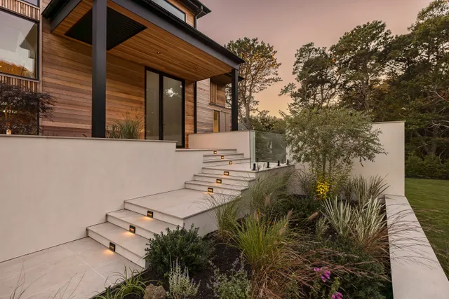 a view of a house with backyard and sitting area