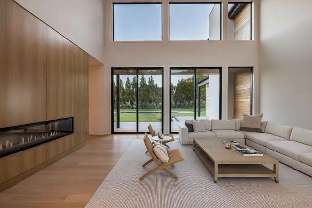 a living room with furniture and large windows