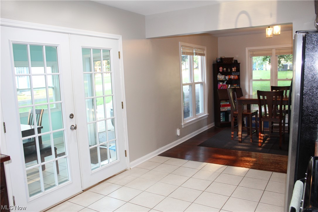1810 Massillon Road Akron, OH 44312 - Photo 26 of 31 Doorway to mud-room and outside featuring a healthy amount of sunlight, french doors, and light tile floors