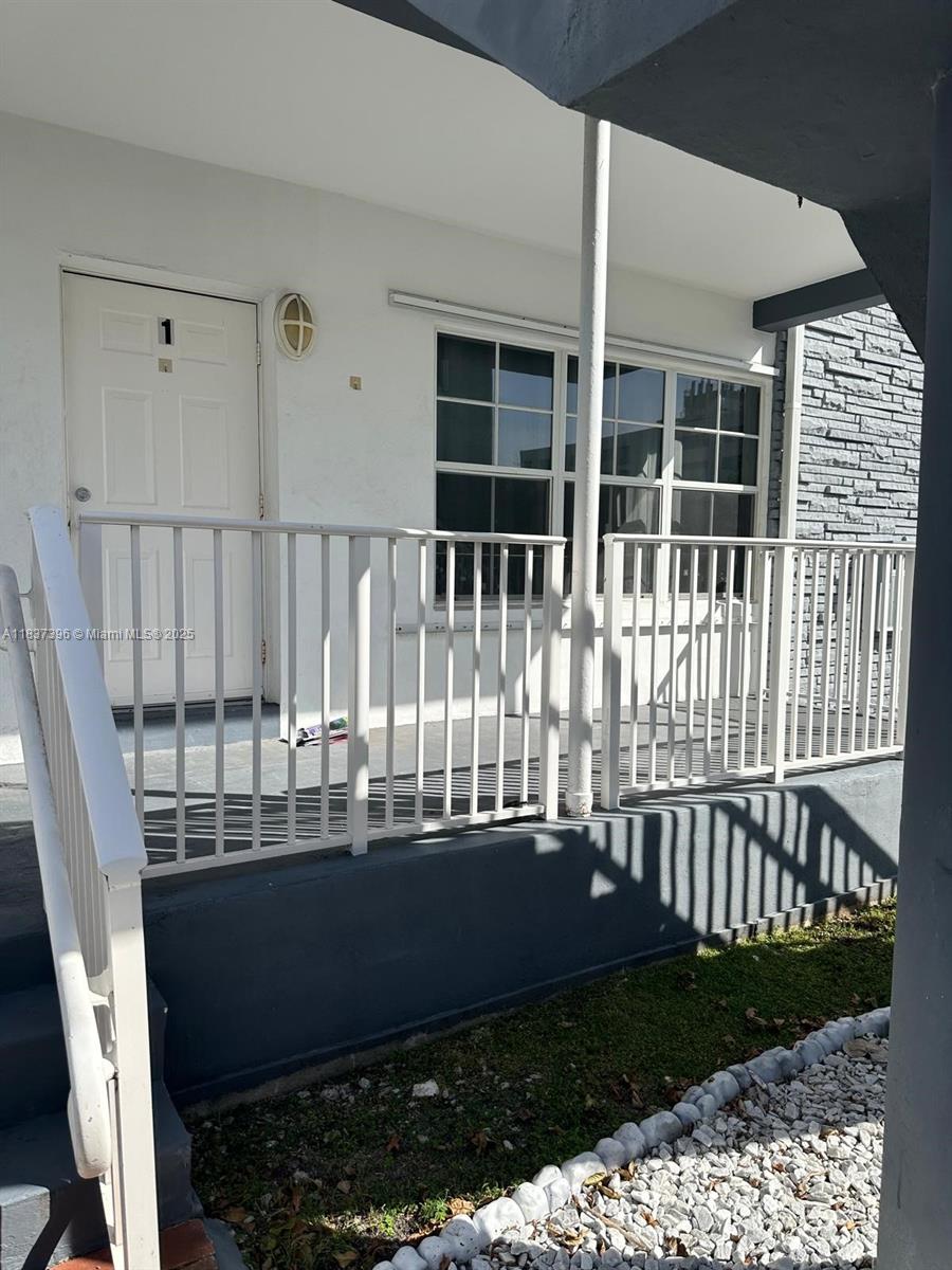 1065 97th Street, Unit 1A Bay Harbor Islands, FL 33154 - Photo 2 of 14 a view of a house with a deck