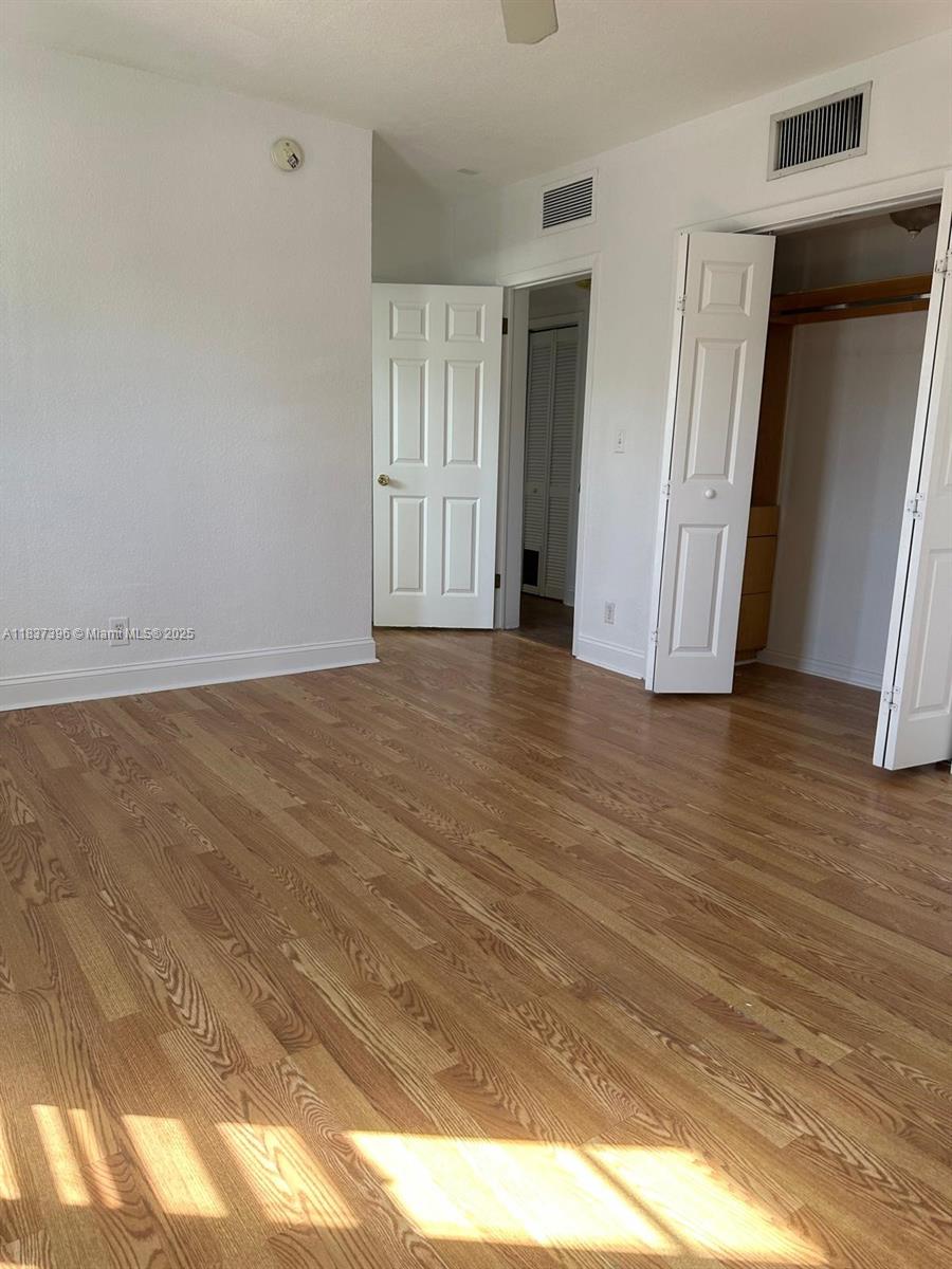 1065 97th Street, Unit 1A Bay Harbor Islands, FL 33154 - Photo 9 of 14 a view of an empty room and wooden floor