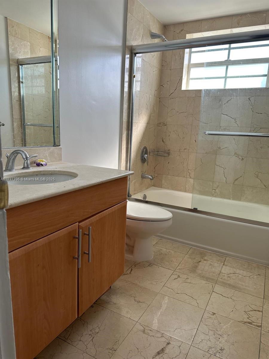 1065 97th Street, Unit 1A Bay Harbor Islands, FL 33154 - Photo 10 of 14 a bathroom with a sink and a mirror