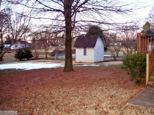 212 Cardwell Road Mayodan, NC 27027 - Photo 3 of 16 Other. Fenced in level back yard with storage building, established trees, deck, and dog run.