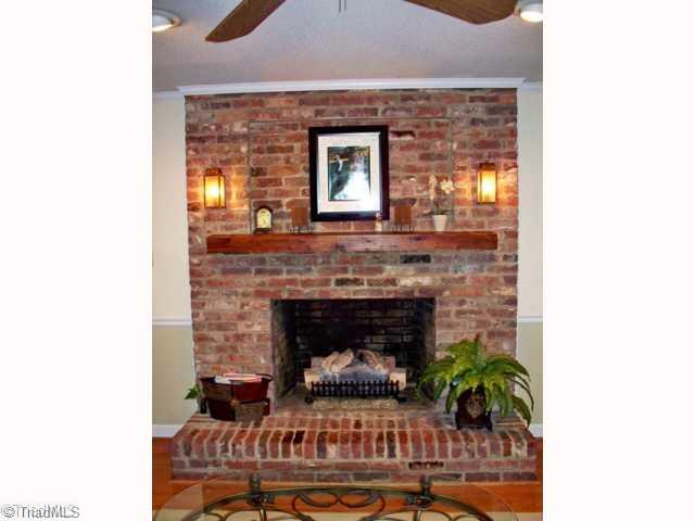 212 Cardwell Road Mayodan, NC 27027 - Photo 5 of 16 Other. Stunning solid brick fireplace in the living room with raised hearth, inset fram above the wooden mantle, and sconce lighting.