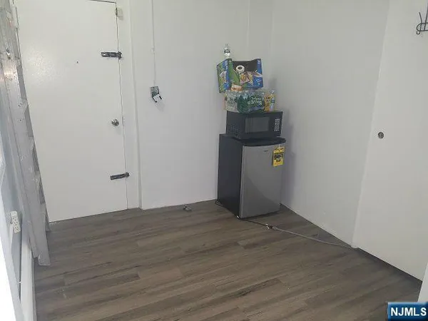 a white toilet sitting next to a white sink and vanity