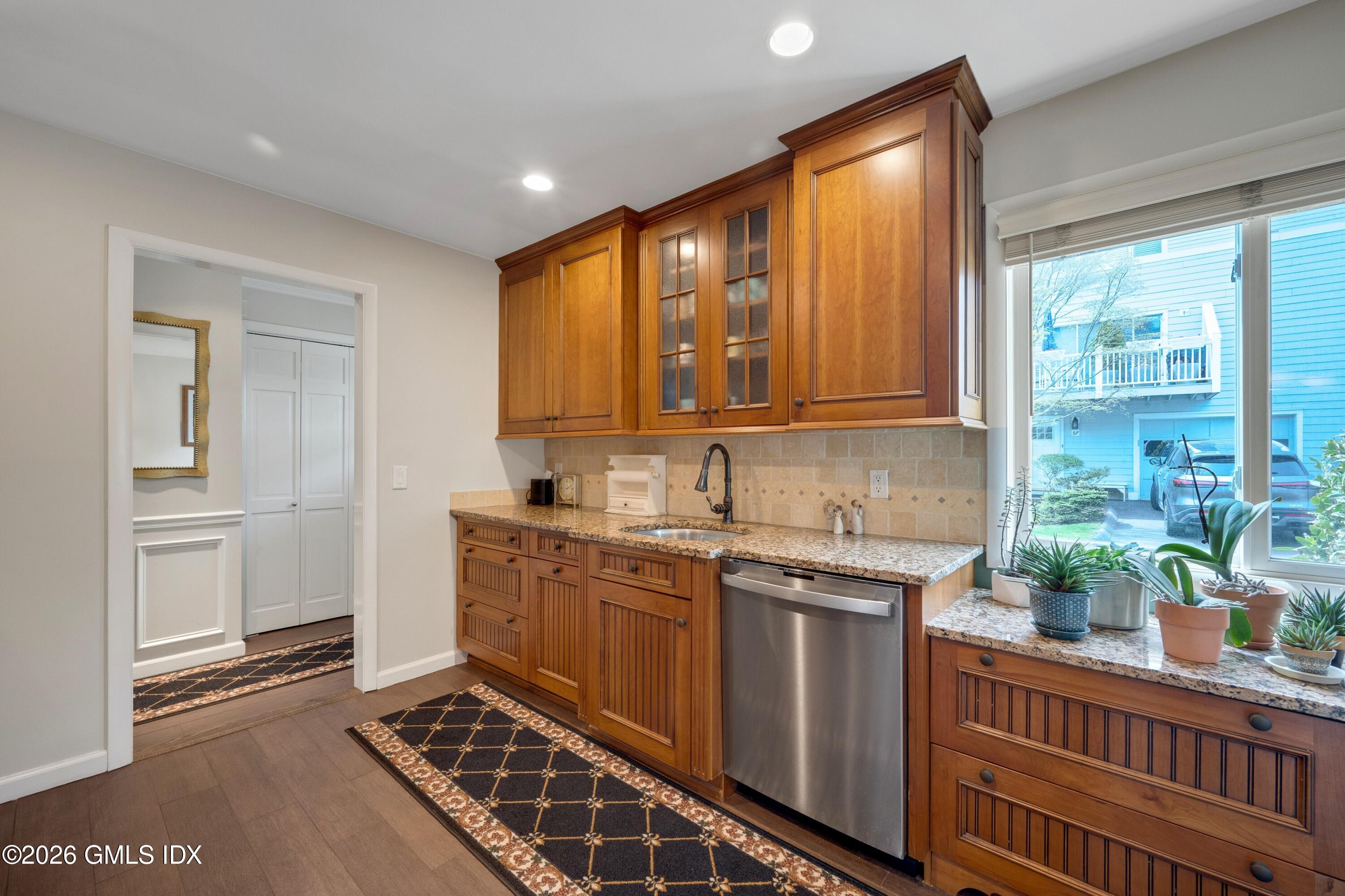 58 Stirrup Lane, Unit 58 Riverside, CT 06878 - Photo 4 of 23 a kitchen with stainless steel appliances granite countertop a stove a sink and a microwave