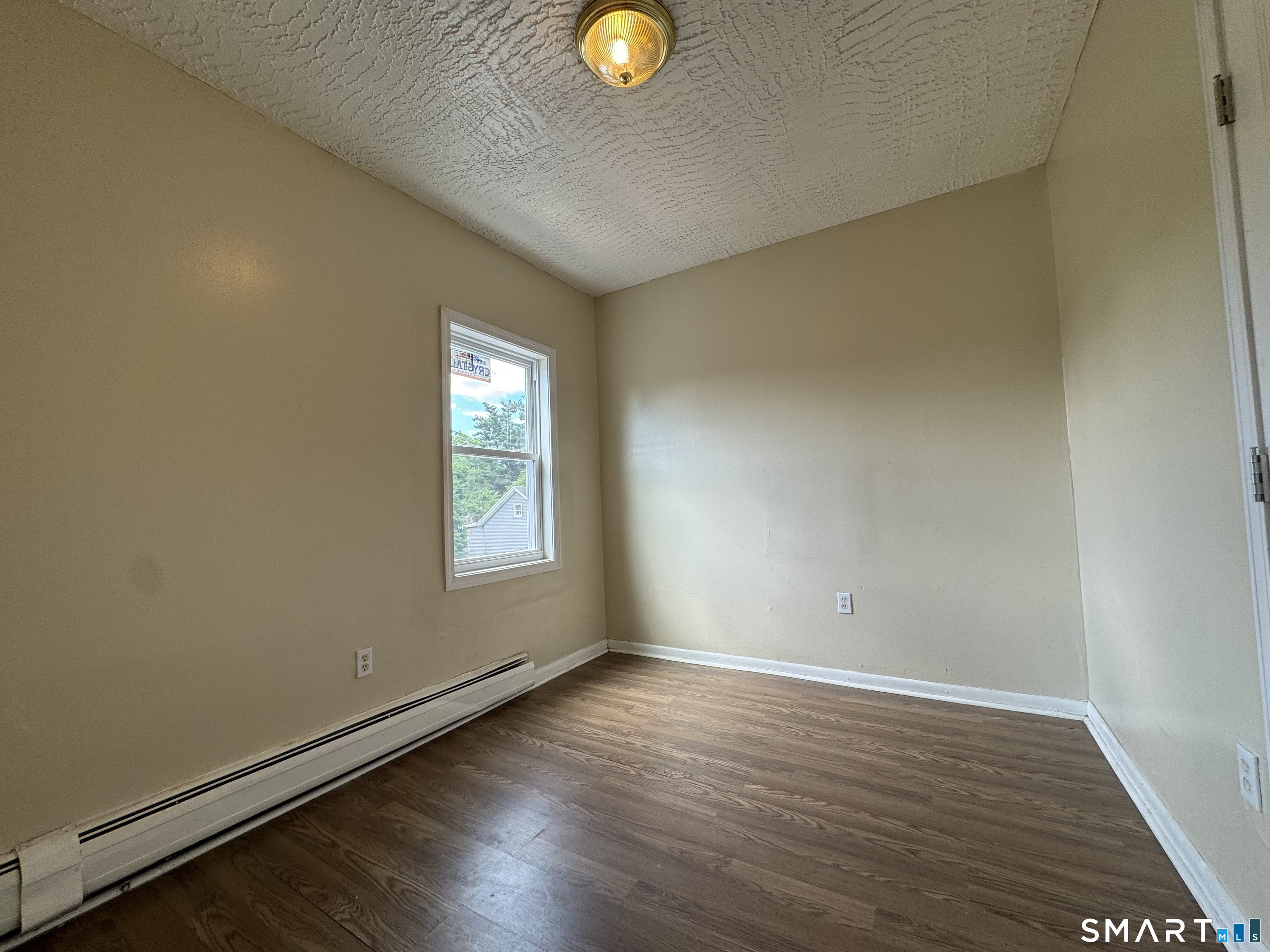 38 Green Street Waterbury, CT 06708 - Photo 12 of 17 a view of an empty room with window and wooden floor