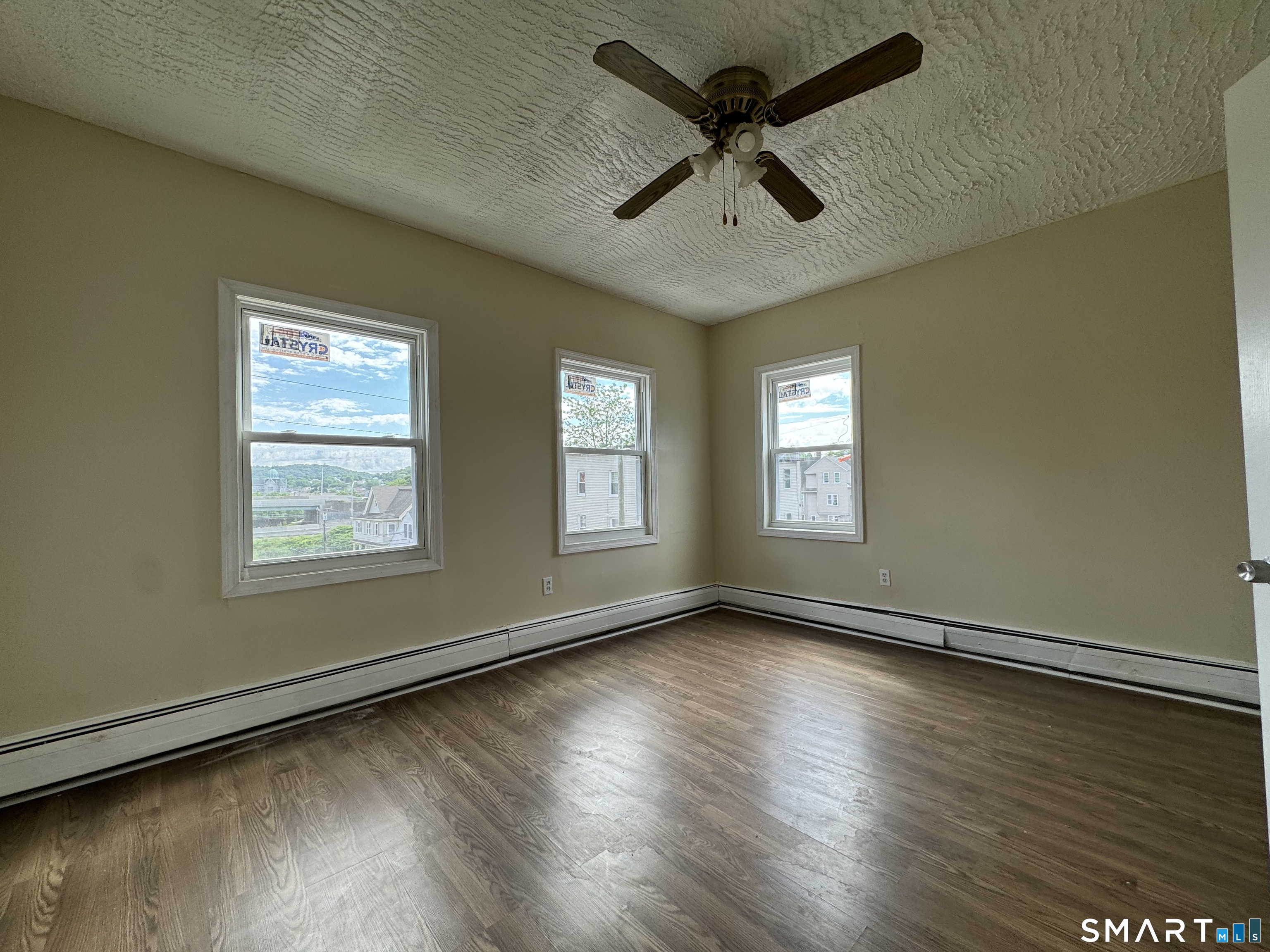38 Green Street Waterbury, CT 06708 - Photo 4 of 17 a view of an empty room with wooden floor and a window