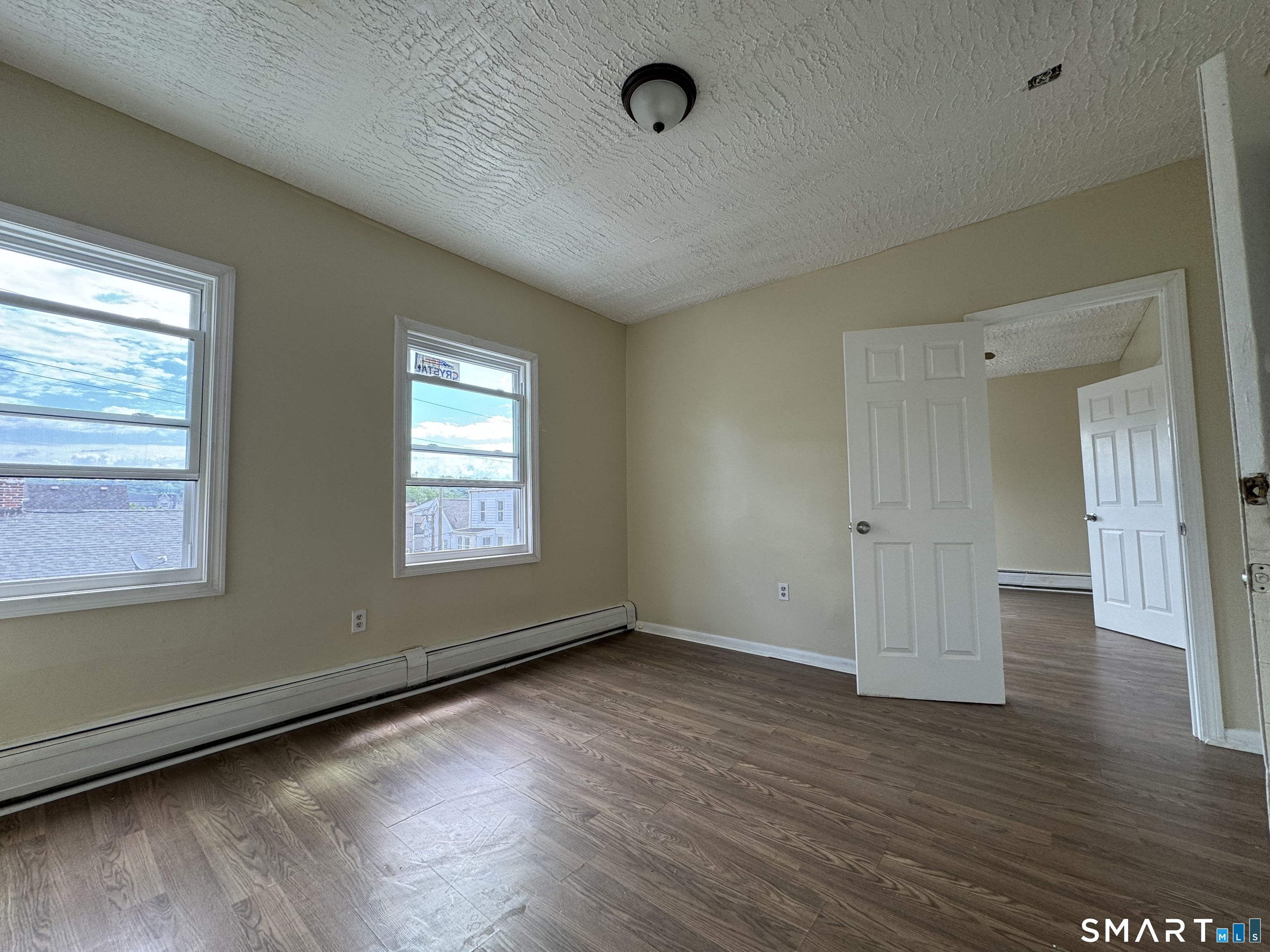 38 Green Street Waterbury, CT 06708 - Photo 6 of 17 a view of an empty room with wooden floor and a window