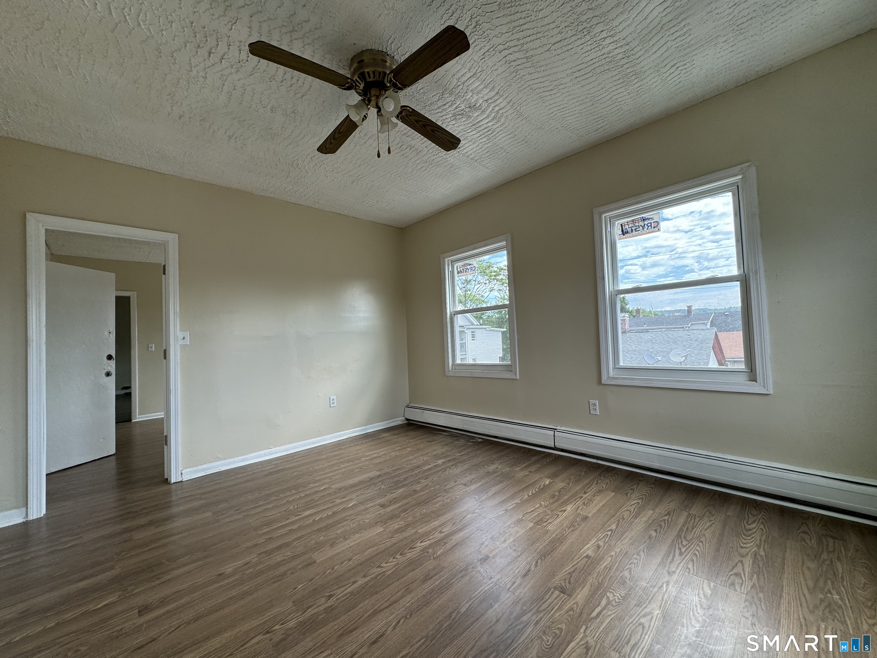 38 Green Street Waterbury, CT 06708 - Photo 8 of 17 a view of an empty room with wooden floor and a window