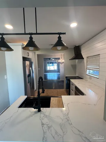 a living room with large furniture and a chandelier