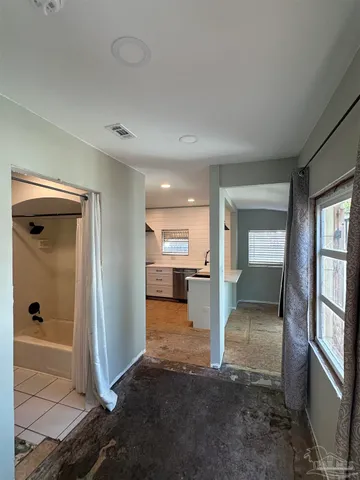 a view of a hallway with furniture and a livingroom