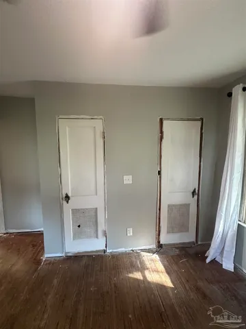 a bedroom with a bed and a mirror