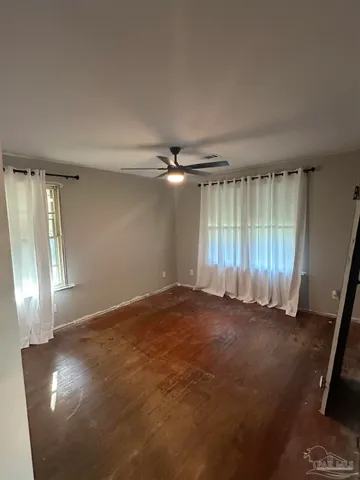 an empty room with windows and closet