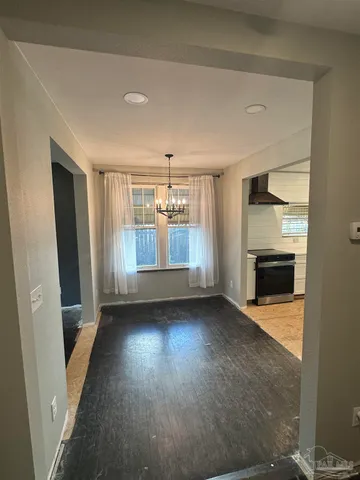 wooden floor in an empty room with a fireplace