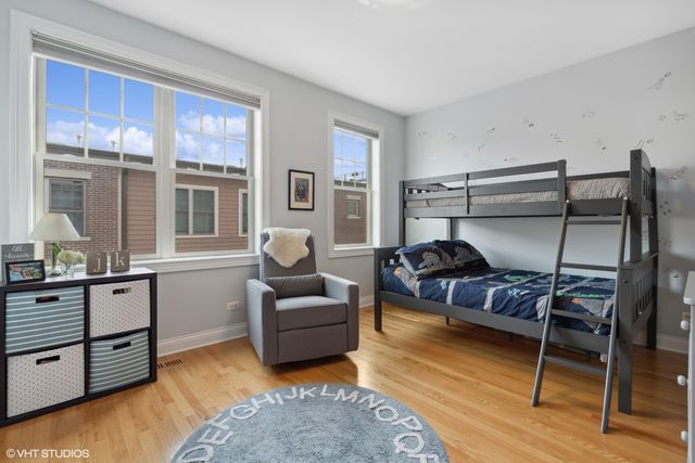 a bedroom with furniture and wooden floor