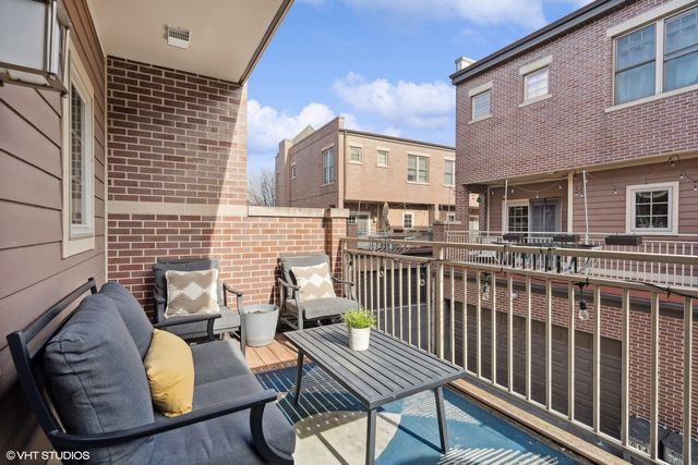 a view of a chairs and table in the balcony