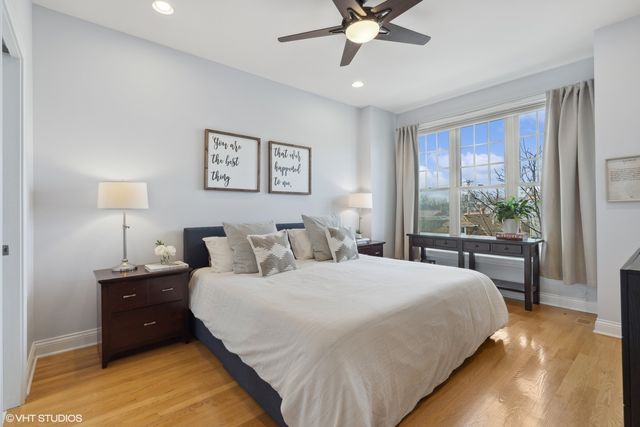 a bedroom with a bed and a large window