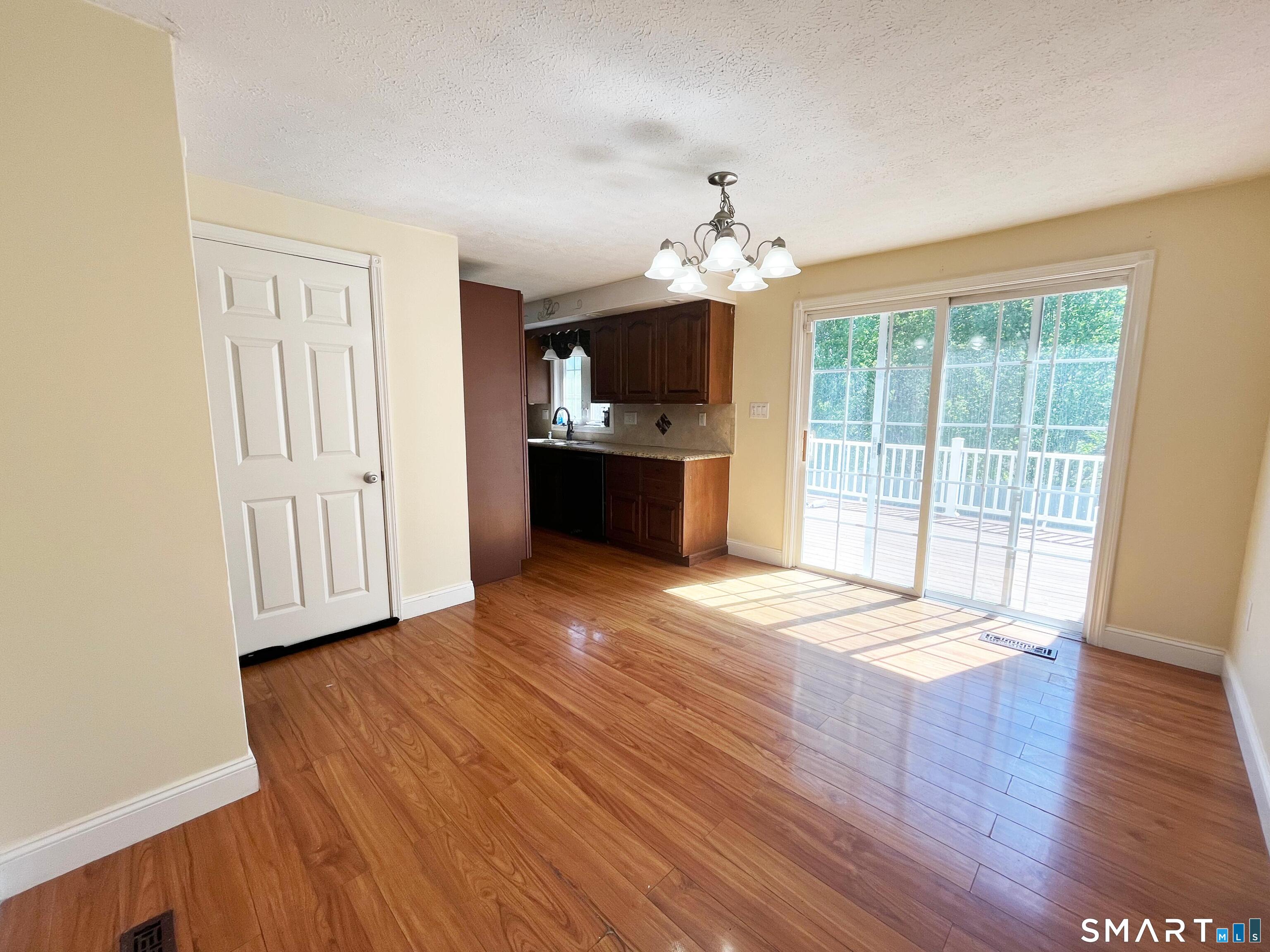 52 Monce Road Burlington, CT 06013 - Photo 18 of 26 a view of an empty room with wooden floor and a window