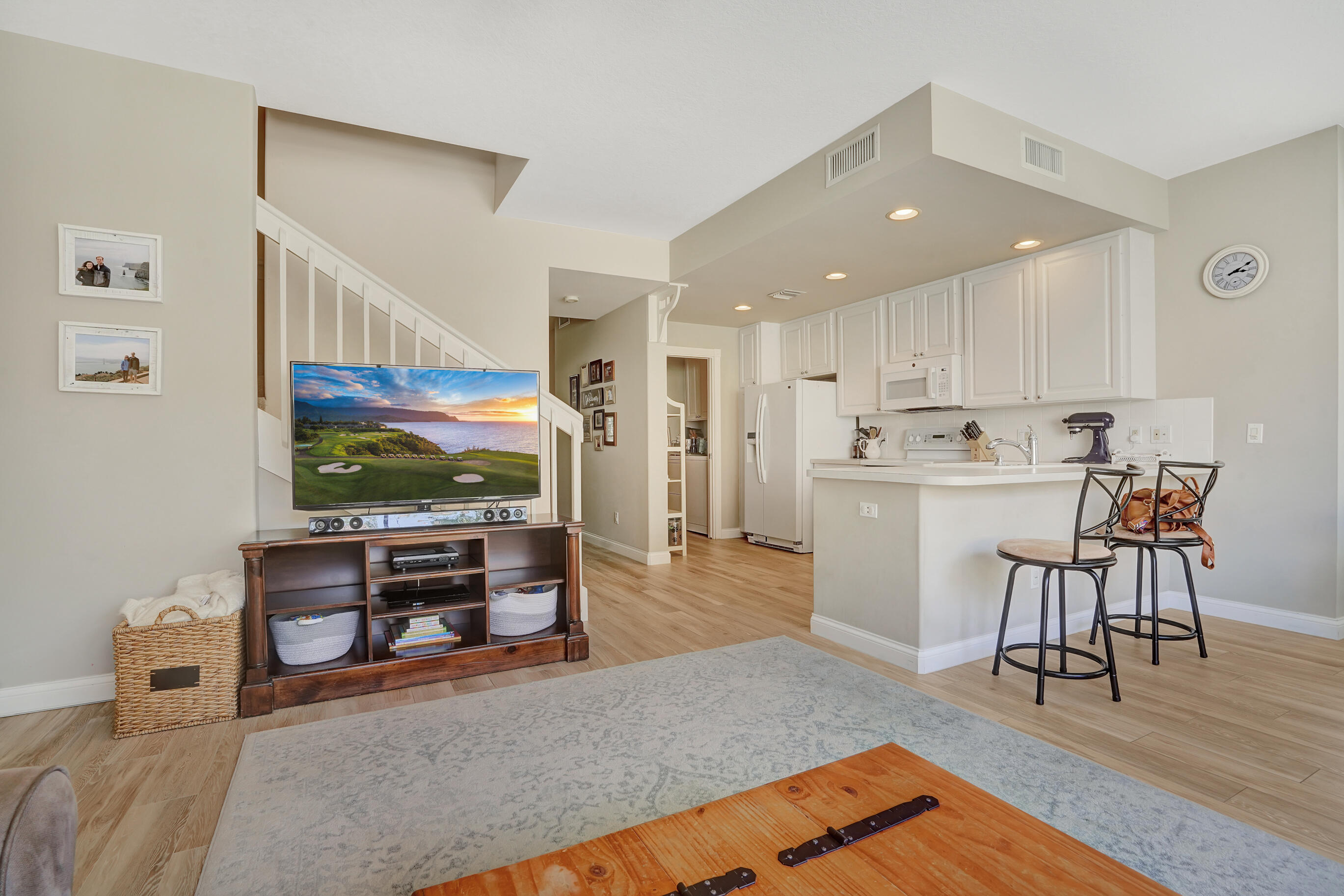 1687 Frederick Small Road Jupiter, FL 33458 - Photo 3 of 27 a living room with stainless steel appliances furniture and a flat screen tv