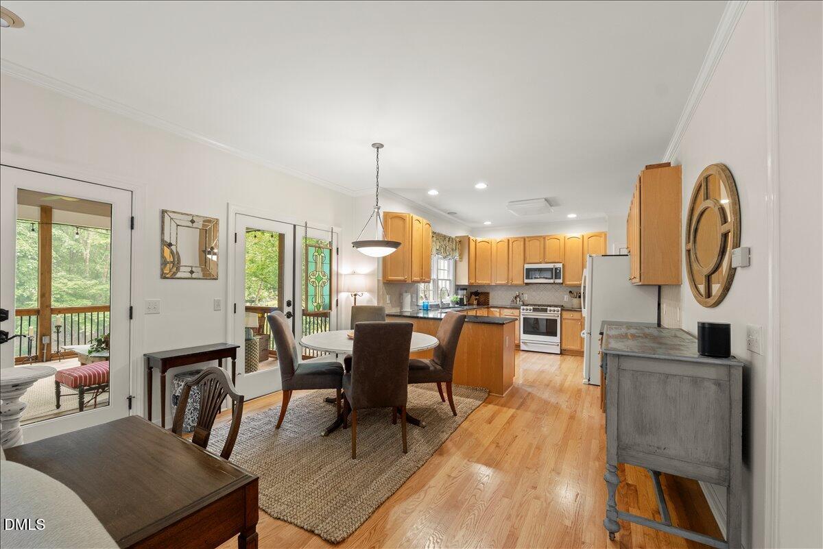 109 Hemingway Forest Place Raleigh, NC 27607 - Photo 11 of 33 a living room with furniture a rug kitchen view and a large window