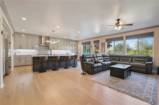 a large kitchen with lots of counter space a sink a window and chairs