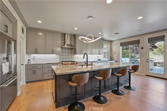 a kitchen with stainless steel appliances granite countertop a sink and stove