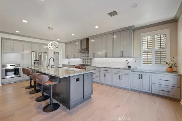 a large kitchen with granite countertop a large counter top and sink