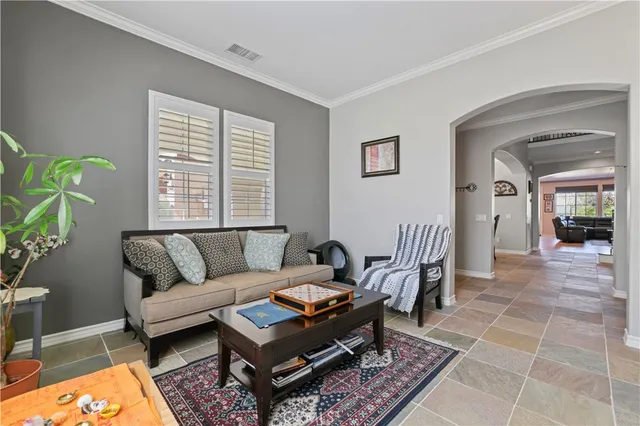 a living room with furniture a rug and a window