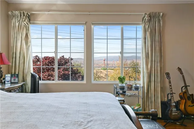 a bedroom with a large bed and a chandelier