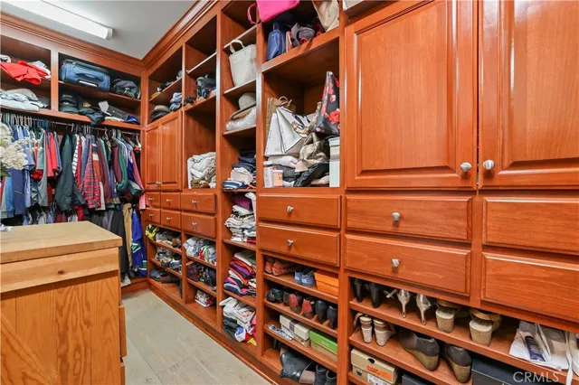 a bedroom with a bed and painting on the wall