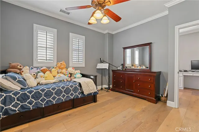 a view of a patio with couches table and chairs with potted plants and a barbeque