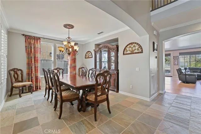 a view of a dining room with furniture and chandelier