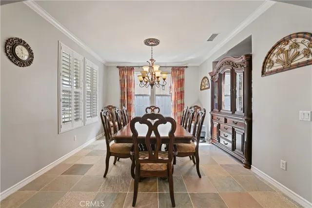 a view of a dining room with furniture window and chandelier
