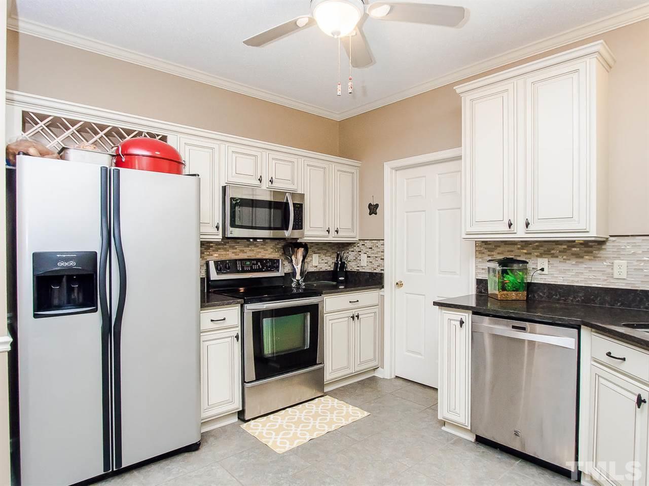 3400 Ribcowski Court Raleigh, NC 27616 - Photo 11 of 25 a kitchen with stainless steel appliances granite countertop a refrigerator a stove top oven a sink and dishwasher