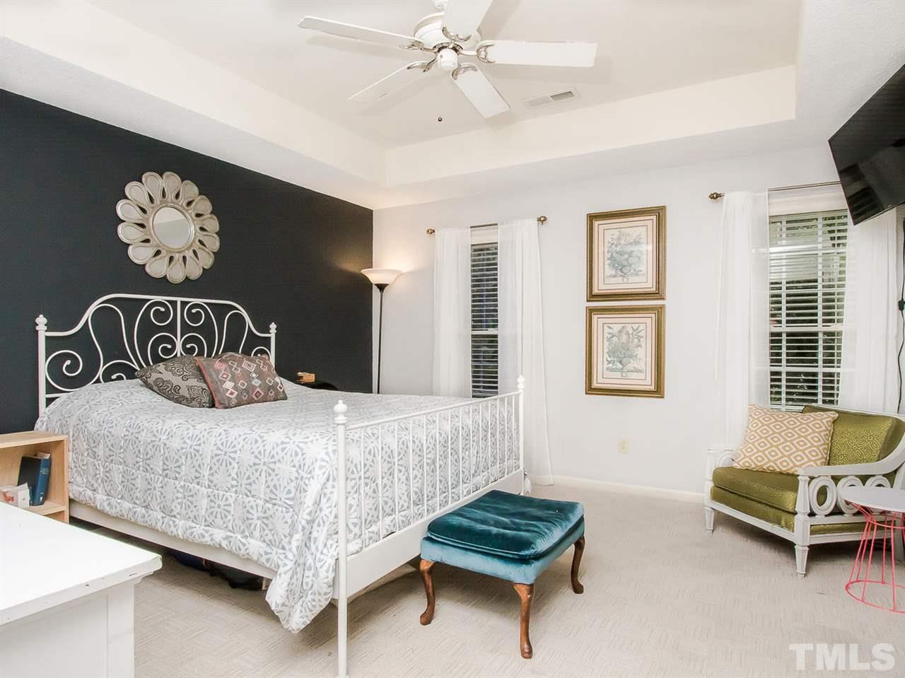 3400 Ribcowski Court Raleigh, NC 27616 - Photo 13 of 25 a bedroom with a bed and a chandelier