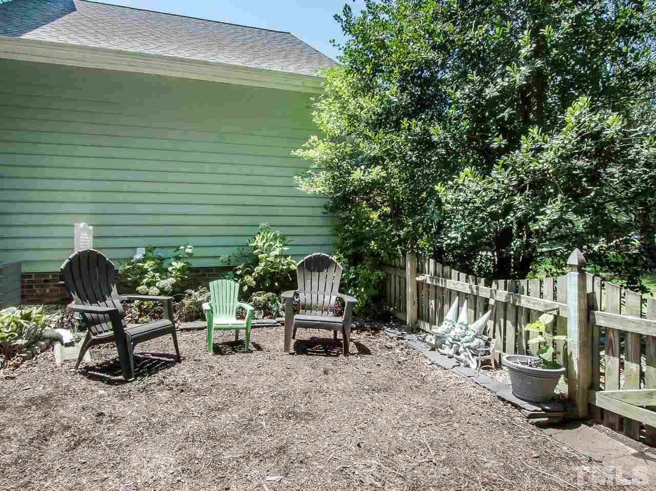 3400 Ribcowski Court Raleigh, NC 27616 - Photo 23 of 25 a backyard of a house with table and chairs