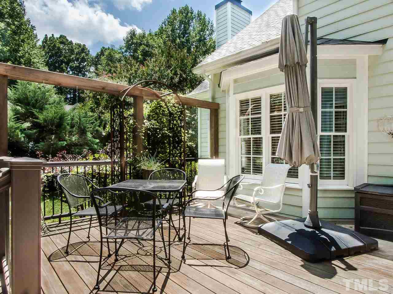 3400 Ribcowski Court Raleigh, NC 27616 - Photo 25 of 25 a view of a patio with table and chairs with wooden floor and fence